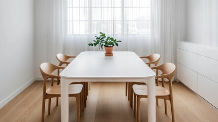 Fototapeta premium A minimalist dining room showcasing a white table, natural wood chairs, and a small potted plant as decor
