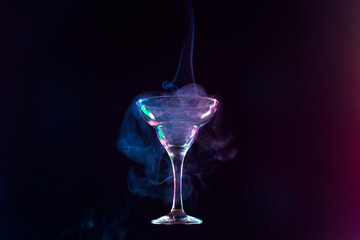 levitating wine glass full of smoke on a black background