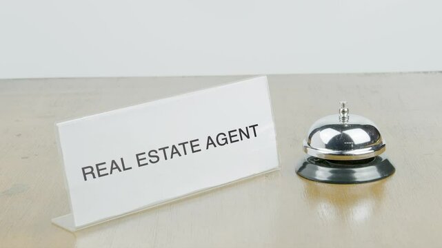 Real estate agent Room Office or Room with Hand Ringing The Bell on Desk or Table Multiple Times