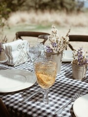 Table setting, check tablecloth, flowers, garden lunch