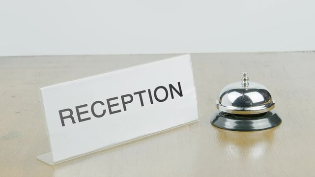 Reception Office or Room with Hand Ringing The Bell on Desk or Table Multiple Times