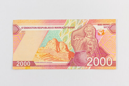 Uzbekistan 2000 So'm banknote featuring Varahsha ruins of the ancient caravan route Poykend, clay pot and artifact, camel