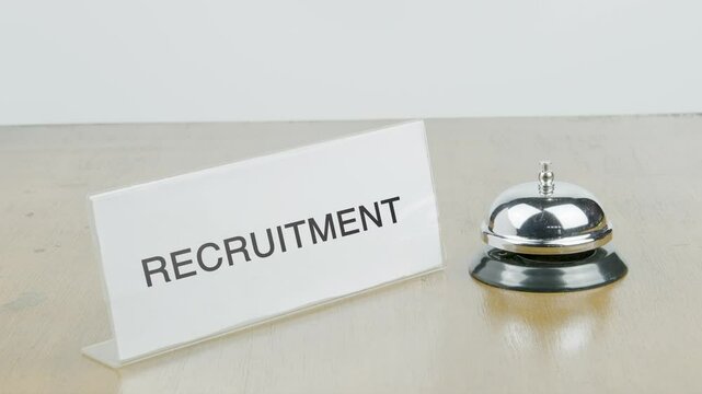 Recruitment Office or Room with Hand Ringing The Bell on Desk or Table Multiple Times