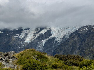 beautiful view of ice-covered mountains in new Zealand among the clouds