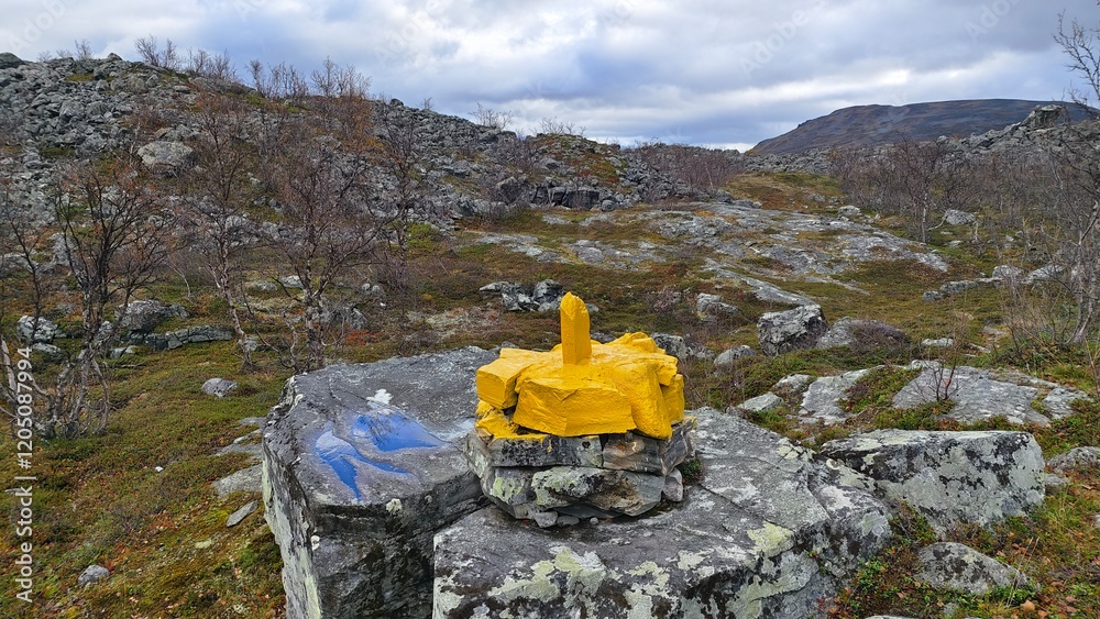 Wall mural Border stone on the border between Norway and Finland in the wild Nordic tundra