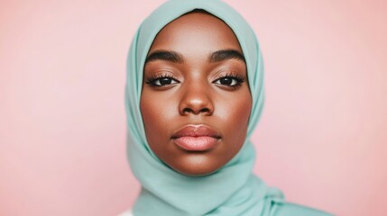 A young woman wearing a mint green hijab