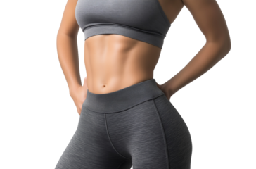 Close-up of a perfectly toned female abdomen with six-pack abs, wearing yoga pants against a transparent background