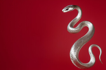 Fototapeta premium Golden snake on a red background, Chinese New Year concept