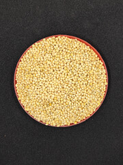 Millet seeds in red container. Millet seeds for bird feed.