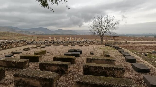 Ruins of ancient structures at Tel Hazor in the Galilee, northern Israel, captured on a cloudy winter day, offering a glimpse into the region's rich archaeological heritage.