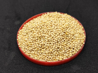 Millet seeds in red container. Millet seeds for bird feed.