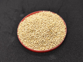 Millet seeds in red container. Millet seeds for bird feed.
