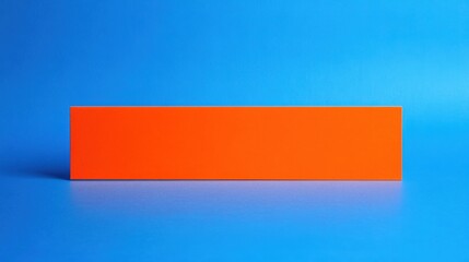 A vibrant orange rectangular block set against a bright blue background, ideal for creative projects or design concepts.