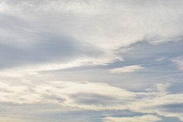 Layered altostratus clouds with shades of gray and white covering most of the sky