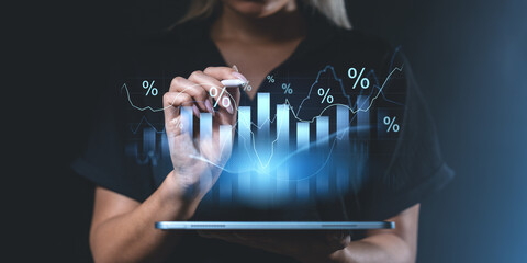 Woman interacting with futuristic financial graphs and percentage symbols.