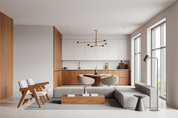 Modern kitchen and living room interior with wooden cabinets, dining table, and cozy seating area in a bright space with large windows. 3D Rendering