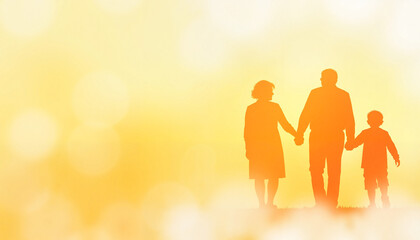 Silhouetted family walking hand in hand against yellow background
