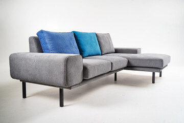 Modern Gray Sofa with Blue Cushions in Minimalistic Indoor Setting..
