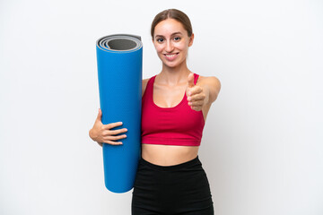 Young sport caucasian woman going to yoga classes while holding a mat isolated on white background shaking hands for closing a good deal © luismolinero