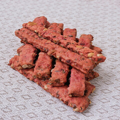 Homemade cookie sticks with seeds and vegetables, laid out on a linen napkin