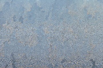 Frost patterns on window glass revealing intricate designs during a cold winter morning