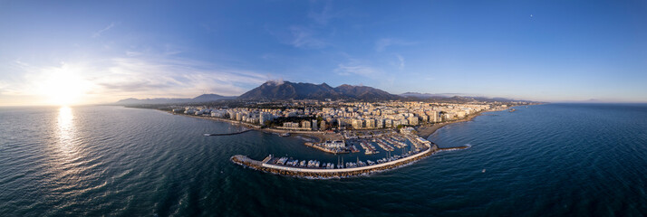 Wide aerial panorama Marbella luxury yacht sports port with boulevard and historic city center in...