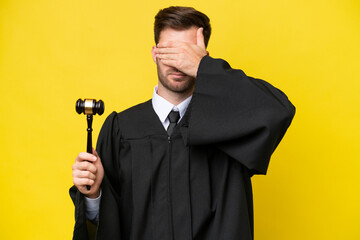Judge caucasian man isolated on yellow background covering eyes by hands. Do not want to see...