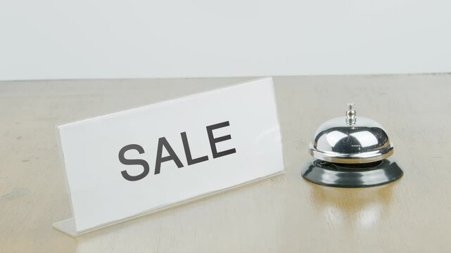 Sale Office or Room with Hand Ringing The Bell on Desk or Table Multiple Times