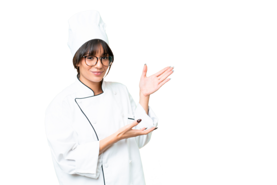 Young caucasian chef  woman over isolated chroma key background extending hands to the side for inviting to come