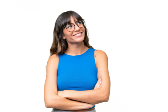 Young caucasian woman over isolated background looking up while smiling