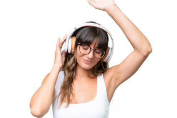 Young caucasian woman over isolated background listening music and dancing