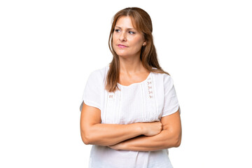 Middle-aged caucasian woman over isolated background looking to the side