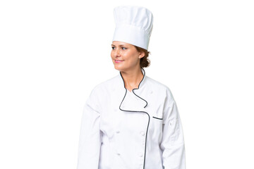 Middle-aged chef woman over isolated background looking side