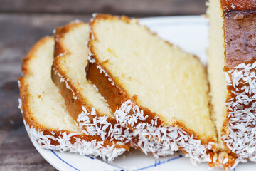 Sliced homemade cocount cake on the table.