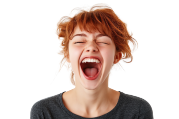 A joyful young woman with curly red hair laughs heartily, showcasing pure happiness and spontaneity in a vibrant moment of laughter.