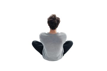 A person sitting cross-legged in a meditative pose, reflecting on inner thoughts and emotions. Ideal for themes of mindfulness and mental wellness.