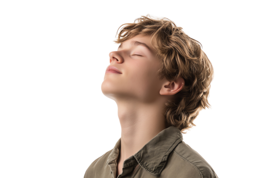 A young boy enjoys a moment of tranquility, with his eyes closed and head tilted back, embodying serenity and reflection in a peaceful atmosphere.