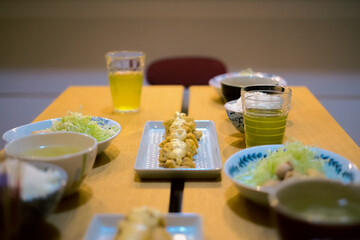 Dinner menu with Miyazaki specialty, Nanban Chicken on a wooden table with ocha tea