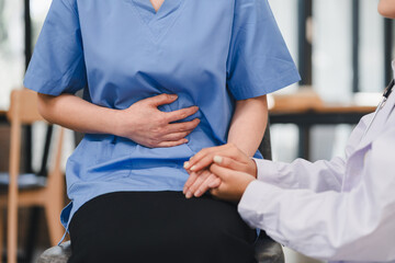Stomach ache, cramps and hands of woman with abdomen pain due to constipation, menstruation or ibs...