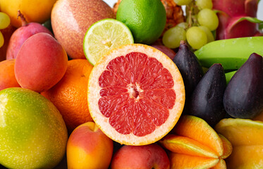 Closeup view of basket full of fresh mixed ripe colorful fruit. Tropical, seasonal, healthy eating concept