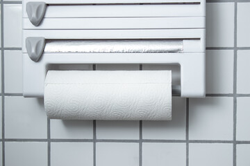 A kitchen paper towel roll hanging on the wall in the kitchen 