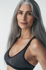 Fototapeta premium A woman with gray hair wearing a black bra top, one informative phrase about what pictured on image