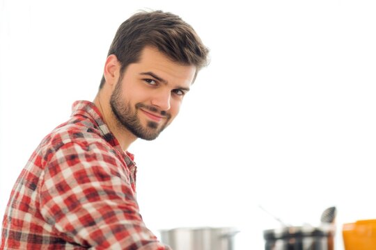 A man wearing a red and white checkered shirt, straightforwardly pictured
