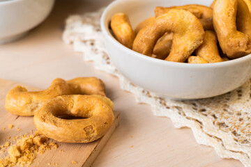 Artisanal homemade typical apulian taralli, used as a baked snack in south italian culture.
