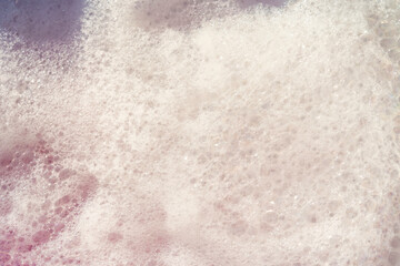 Fluffy White Soap Foam Floating in a Jacuzzi Under Sunlight, Perfect for Spa, Wellness, and Relaxation-Themed Concepts in a Natural Setting
