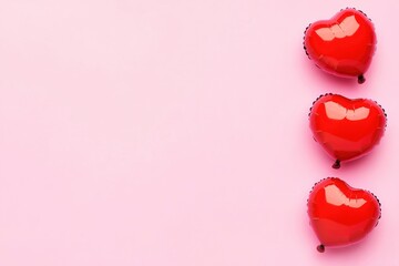 A row of red heart-shaped balloons on a pink background, suitable for Valentine's Day or romantic events