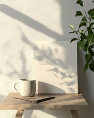 Blank canvas mockup with coffee cup, pen, and plant on wooden table.