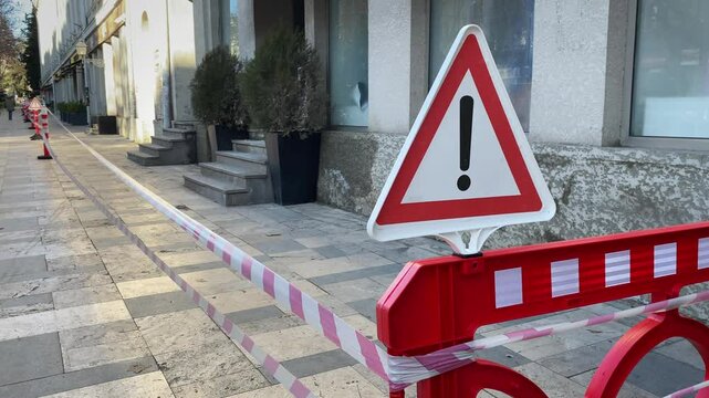 Red barrier with stretched plastic tapes. Prohibition of passage of the building after a fire or crime incident.