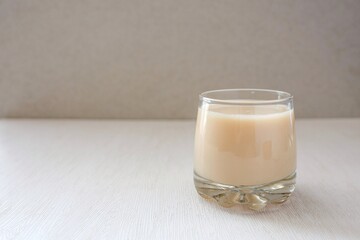 Glass of milk on white background