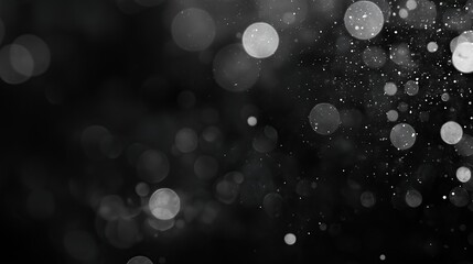 a bokeh of white snow on a black background